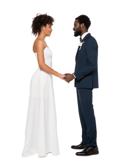 happy african american bridegroom and bride holding hands while looking at each other isolated on